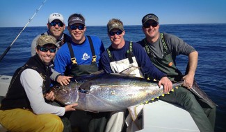 photo - group of friends catch yellowfin tuna on charter trip with mgfc
